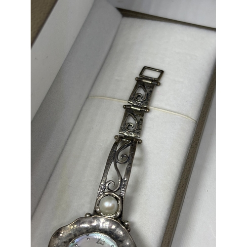 649 - A MARKED SILVER AND MOTHER OF PEARL WATCH IN A PRESENTATION BOX