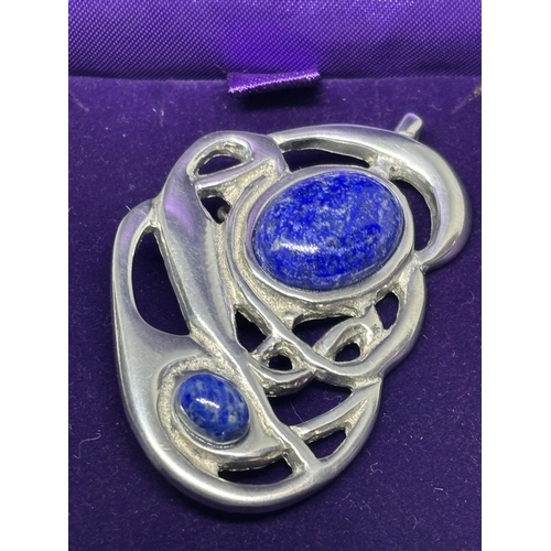 659 - A ST JUSTIN PEWTER AND BLUE STONE BROOCH IN ORIGINAL PRESENTATION BOX