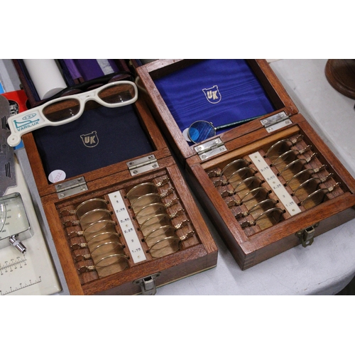 18 - A COLLECTION OF VINTAGE OPTICIANS EQUIPMENT TO INCLUDE BOXED OPTHALMOSCOPES, TWO OPTHALMIC TRIAL LEN... 