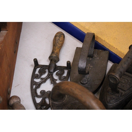 45 - FOUR VINTAGE CAST IRONS TO INCLUDE A CHARCOAL IRON, LACE IRON, ETC PLUS TWO IRON TRIVETS