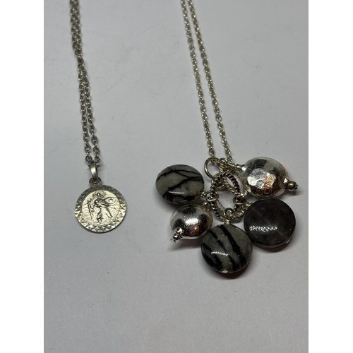 673 - FOUR MARKED SILVER NECKLACES WITH PENDANTS TO INCLUDE A ST CHRISTOPHER