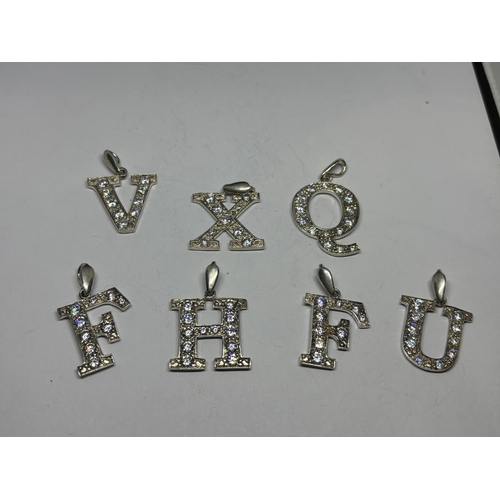 683 - SEVEN LARGE CLEAR STONE INITIAL PENDANTS/KEYRINGS