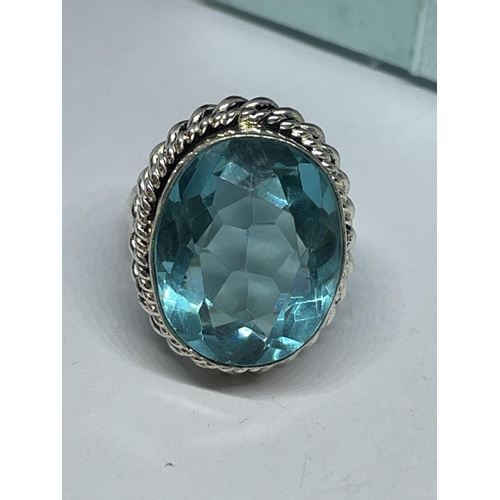 712 - A AMRKED 925 SILVER RING WITH BLUE TOPAZ STONE SIZE L IN A PRESENTATION BOX