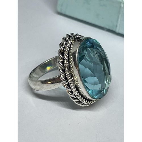 712 - A AMRKED 925 SILVER RING WITH BLUE TOPAZ STONE SIZE L IN A PRESENTATION BOX