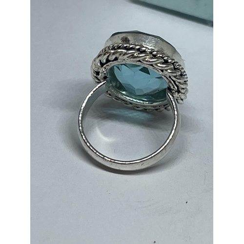 712 - A AMRKED 925 SILVER RING WITH BLUE TOPAZ STONE SIZE L IN A PRESENTATION BOX