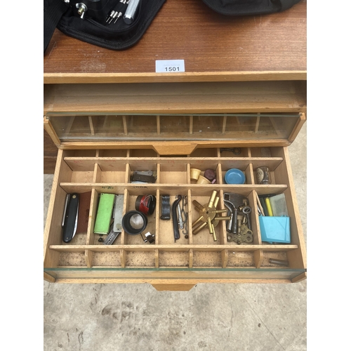 1501 - A TEAK WATCHMAKERS HABERDASHERY CABINET CONTAINING A LARGE SSORTMENT OF WATCH MAKING TOOLS AND SPARE... 