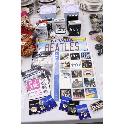 195 - A COLLECTION OF BEATLES ITEMS TO INCLUDE TINS, A TAXI CAR, STICKERS, MAGNETS, BADGES, ETC