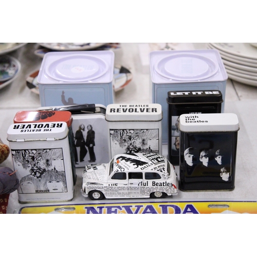 195 - A COLLECTION OF BEATLES ITEMS TO INCLUDE TINS, A TAXI CAR, STICKERS, MAGNETS, BADGES, ETC