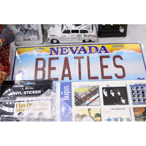 195 - A COLLECTION OF BEATLES ITEMS TO INCLUDE TINS, A TAXI CAR, STICKERS, MAGNETS, BADGES, ETC