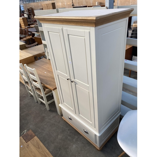 2713 - A TWO DOOR PANELLED WARDROBE WITH DRAWER TO BASE WITH SCOOP HANDLES, 40