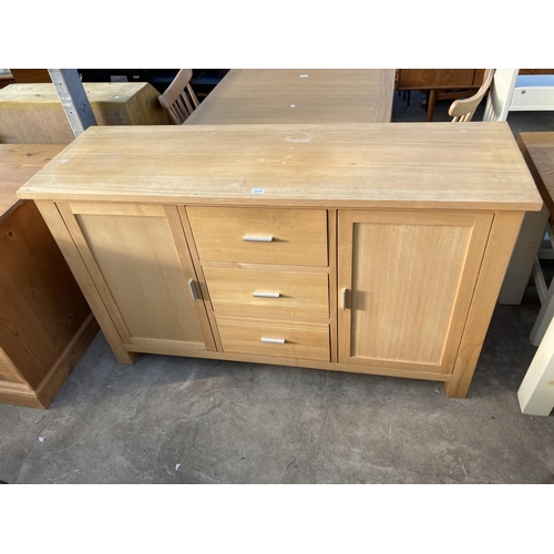 2715 - AN OAK ALAN WARD PANAMA SIDEBOARD ENCLOSING TWO CUPBOARDS, THREE DRAWERS, 59