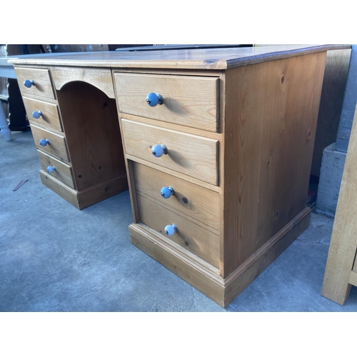 2716 - A PINE TWIN PEDESTAL DESK ENCLOSING SEVEN DRAWERS, 58