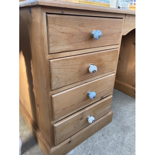 2716 - A PINE TWIN PEDESTAL DESK ENCLOSING SEVEN DRAWERS, 58