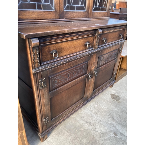 2724 - AN OAK DRESSER WITH GLAZED AND LEADED UPPER PORTION WITH CUPBOARDS AND DRAWERS TO BASE, 48