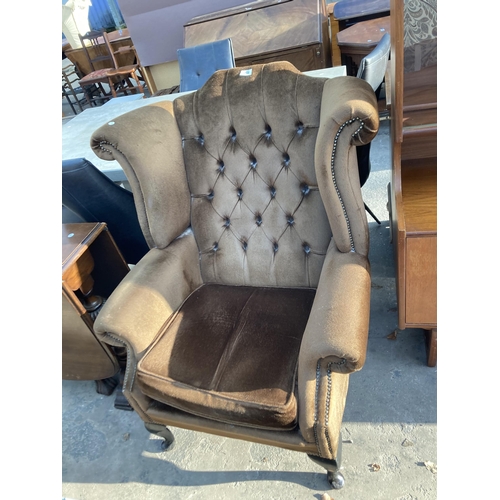 2742 - A WING AND BUTTON BACK FIRESIDE CHAIR ON CABRIOLE LEGS