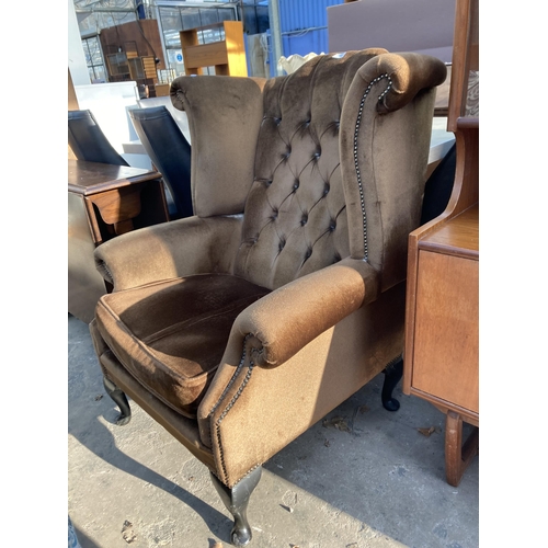 2742 - A WING AND BUTTON BACK FIRESIDE CHAIR ON CABRIOLE LEGS