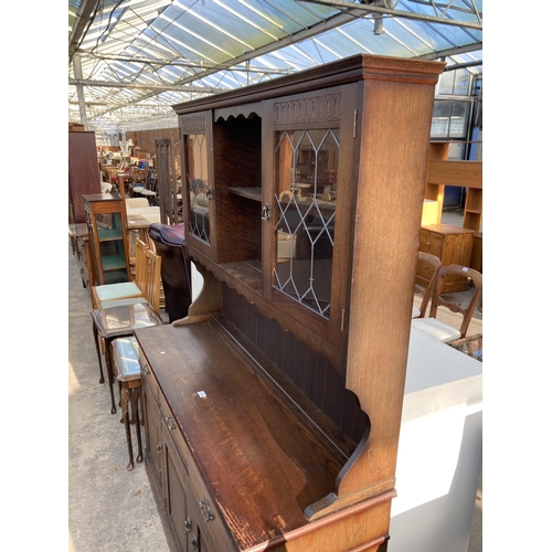 2744 - AN OAK DRESSER WITH GLAZED AND LEADED UPPER PORTION, 55