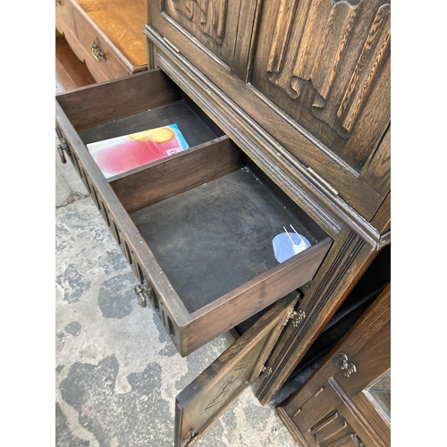 2748 - AN OAK COCKTAIL CABINET WITH LINEN FOLD PANEL, SINGLE DRAWER AND CUPBOARDS TO BASE, 29.5