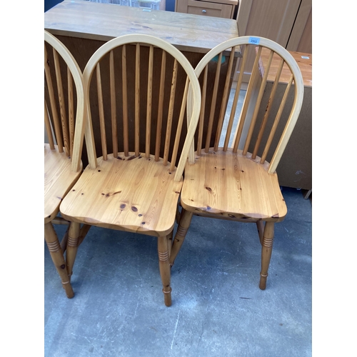 2802 - A SET OF FOUR PINE WINDSOR STYLE KITCHEN CHAIRS