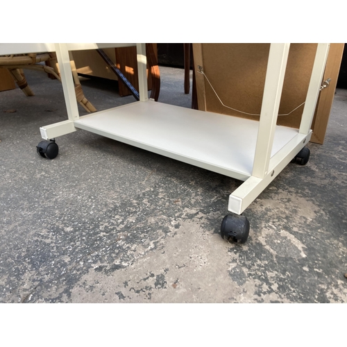 2893 - A MOBILE WORKSTATION ON CASTORS WITH DROP LEAF AND TWO PULL OUT SECTIONS