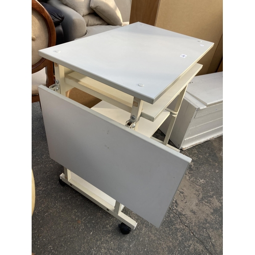 2893 - A MOBILE WORKSTATION ON CASTORS WITH DROP LEAF AND TWO PULL OUT SECTIONS