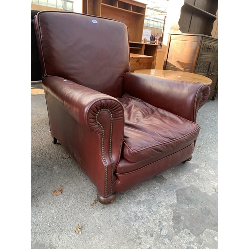 2568 - A LEATHER EASY CHAIR WITH BUN FRONT FEET