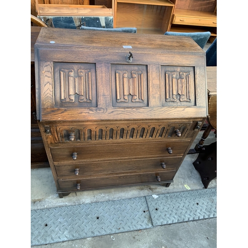 2587 - AN OAK JACOBEAN STYLE BUREAU LINEN FOLD FALL FRONT AND FOUR DRAWERS TO BASE, 30