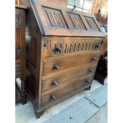 2587 - AN OAK JACOBEAN STYLE BUREAU LINEN FOLD FALL FRONT AND FOUR DRAWERS TO BASE, 30