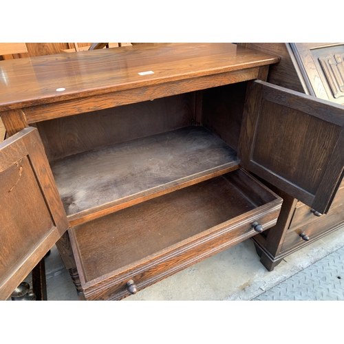 2588 - AN OAK JACOBEAN STYLE TWO DOOR CABINET WITH LINEN FOLD DOORS, SINGLE DRAWER ON OPEN BASE, 31