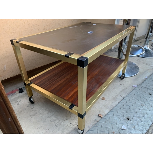 2604 - A METAL FRAMED TWO TIER COFFEE TABLE ON CASTORS