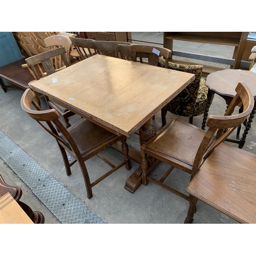 2615 - A MID 20TH CENTURY OAK DRAW LEAF DINING TABLE AND FOUR CHAIRS