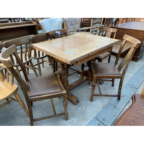 2615 - A MID 20TH CENTURY OAK DRAW LEAF DINING TABLE AND FOUR CHAIRS