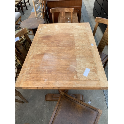 2615 - A MID 20TH CENTURY OAK DRAW LEAF DINING TABLE AND FOUR CHAIRS