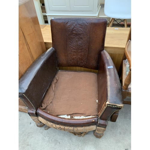 2620 - AN EARLY 20TH CENTURY LEATHER STUDDED FIRESIDE CHAIR