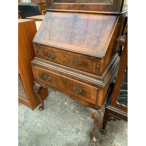 2663 - A QUEEN ANNE STYLE WALNUT AND CROSSBANDED BUREAU BOOKCASE WITH FITTED INTERIOR AND TWO DRAWERS ON CA... 