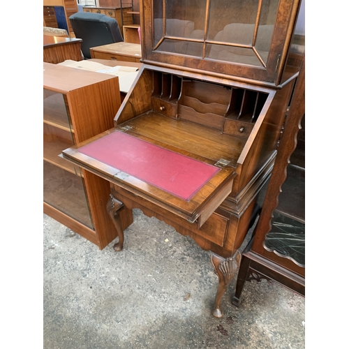 2663 - A QUEEN ANNE STYLE WALNUT AND CROSSBANDED BUREAU BOOKCASE WITH FITTED INTERIOR AND TWO DRAWERS ON CA... 