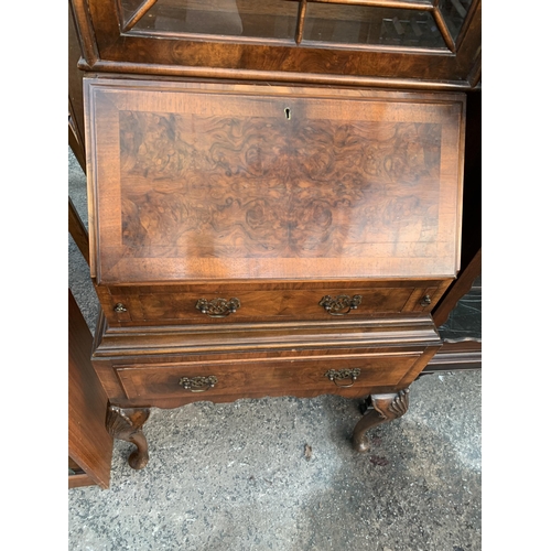 2663 - A QUEEN ANNE STYLE WALNUT AND CROSSBANDED BUREAU BOOKCASE WITH FITTED INTERIOR AND TWO DRAWERS ON CA... 