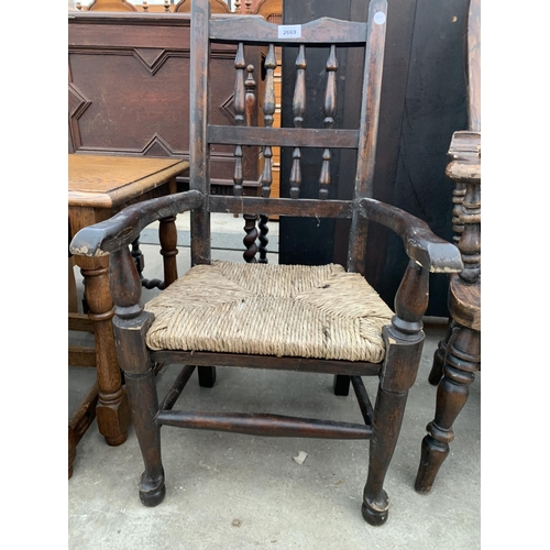 2669 - AN ELM AND BEECH CHILDS ARM CHAIR WITH TURNED SPINDLES AND RUSH SEAT