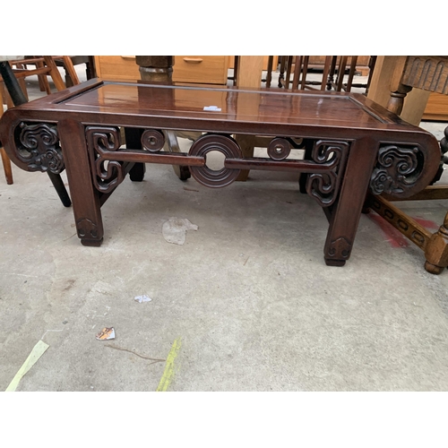 2671 - AN ORIENTAL HARDWOOD COFFEE TABLE WITH CARVED AND PIERCED FOLIATE FRIEZE AND SIDES, 35