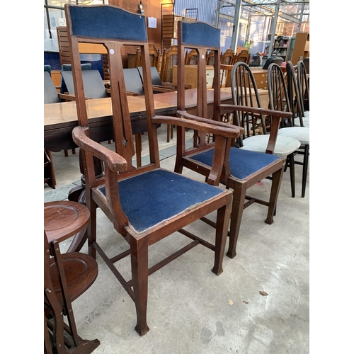 2673 - A PAIR OF OAK EARLY 20TH CENTURY HIGH BACK CARVER CHAIRS