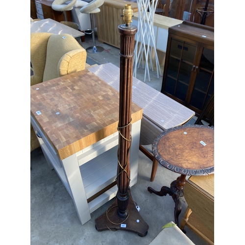 2686 - A MAHOGANY STANDARD LAMP WITH TURNED AND FLUTED COLUMN