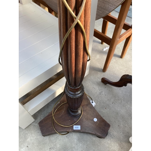 2686 - A MAHOGANY STANDARD LAMP WITH TURNED AND FLUTED COLUMN