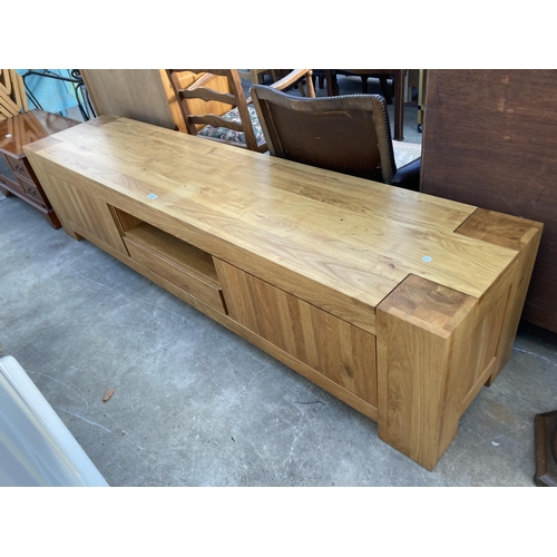 2696 - A HARDWOOD LOW SIDEBOARD ENCLOSING CUPBOARDS AND DRAWERS, 86.5