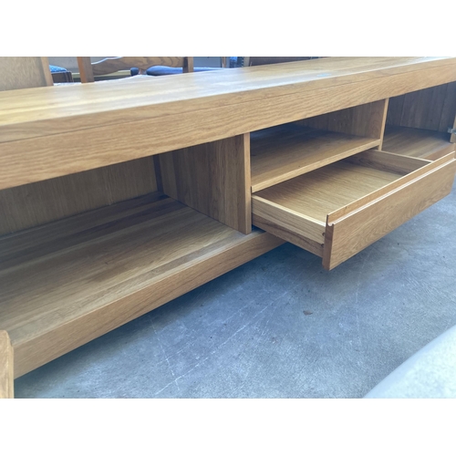 2696 - A HARDWOOD LOW SIDEBOARD ENCLOSING CUPBOARDS AND DRAWERS, 86.5