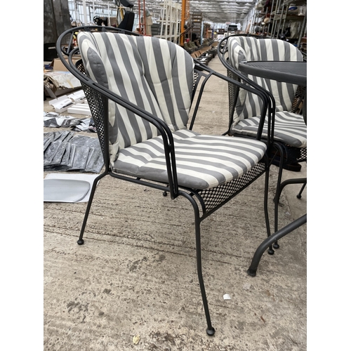 1530 - A LARGE METAL JOHN LEWIS CIRCULAR PATIO TABLE AND FOUR HEAVY METAL CHAIRS COMPLETE WITH CUSHIONS