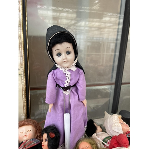 1604 - A LARGE ASSORTMENT OF VINTAGE DOLLS