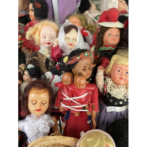 1604 - A LARGE ASSORTMENT OF VINTAGE DOLLS