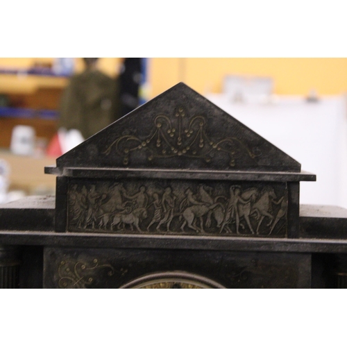 299 - AN EARLY 20TH CENTURY HEAVY SLATE MANTLE CLOCK WITH CLASSICAL CARVING TO THE TOP AND COLUMN DETAIL, ... 