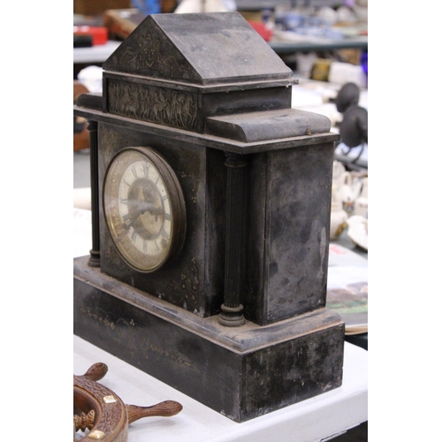 299 - AN EARLY 20TH CENTURY HEAVY SLATE MANTLE CLOCK WITH CLASSICAL CARVING TO THE TOP AND COLUMN DETAIL, ... 