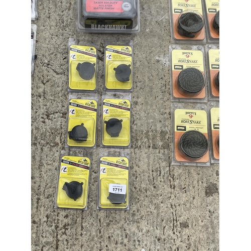 1711 - AN ASSORTMENT OF NEW AND PACKAGED ITEMS TO INCLUDE TASER HOLSTERS, A SCOPE FLIP CAPS ETC